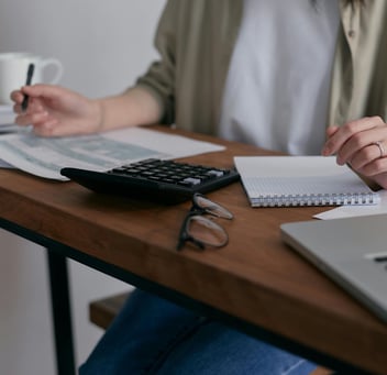 woman at desk with tax forms 